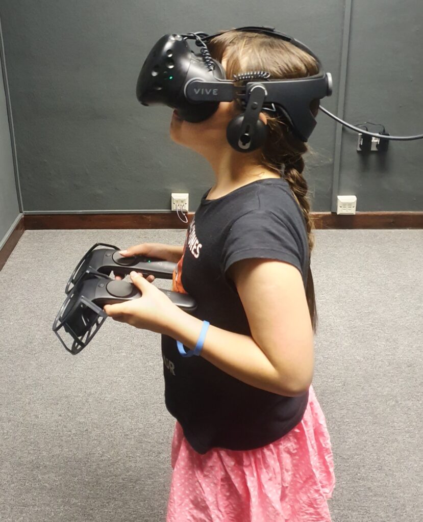 A little girl at Sneaky Dog HQ playing a virtual reality escape room during half term.